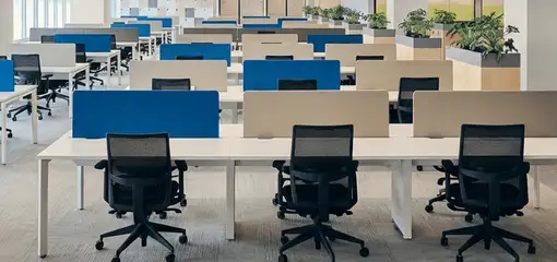 Modern open-plan office space featuring clean workstations, ergonomic chairs, and sanitized carpets provided by professional office cleaning services in Irvine, CA.