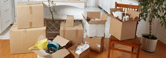 Packed moving boxes and household items in a kitchen before move-out or move-in cleaning, Irvine, CA.